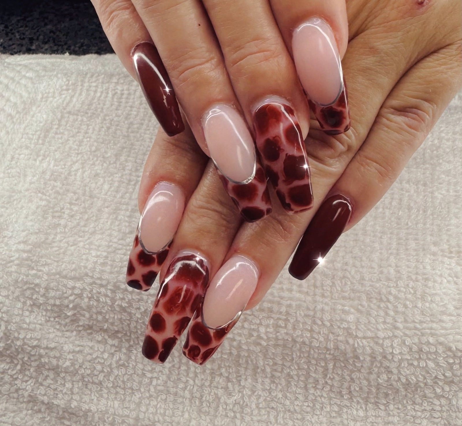 Green floral design on a gel manicure