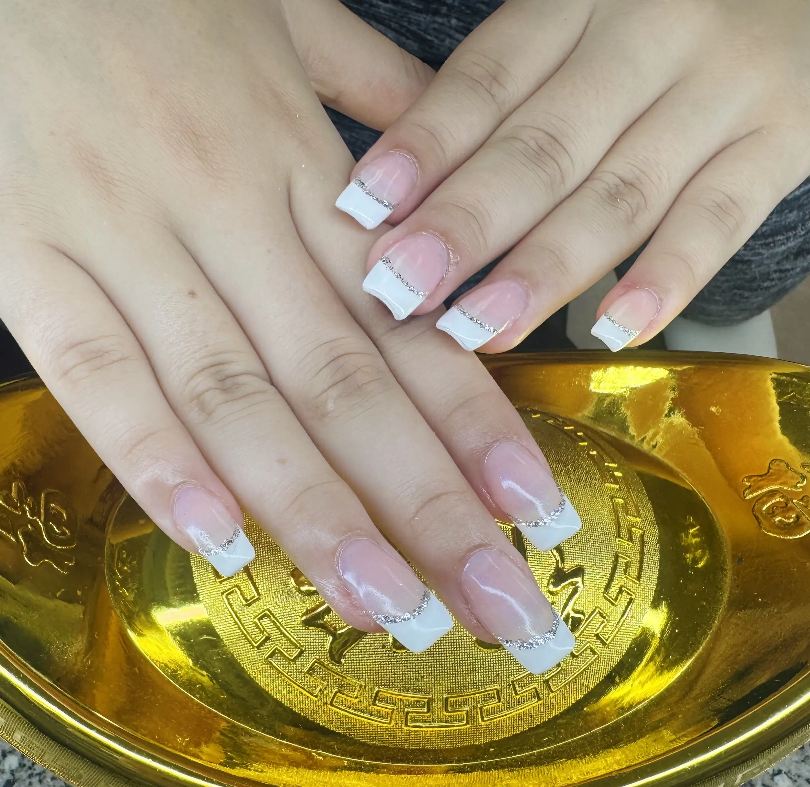 Long French tip nails in a soft nude tone
